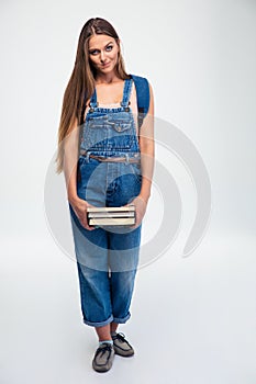 Cute female student holding books