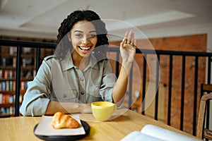 Cute female student, light breakfast in cafe