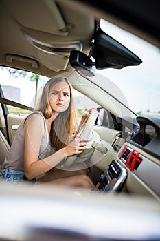 Cute female teen driver enjoying her freshly acquired driving license