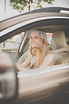 Cute female teen driver enjoying her freshly acquired driving license