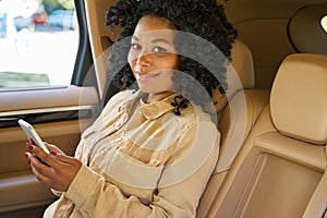 Cute female travels in the back seat of a car