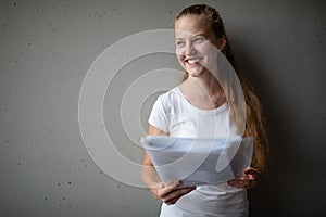 Cute female student with books in library