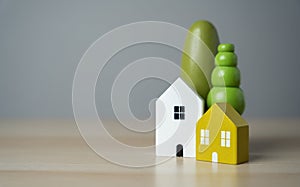 Cute figurines of houses and trees. Buy a nice house. Mortgage loan.
