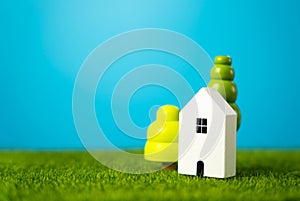Cute figurines of houses and trees. Mortgage loan. Affordable housing. photo