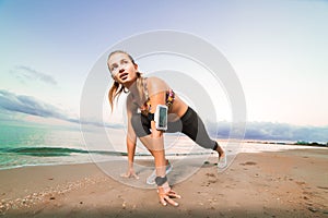 Cute fit girl starts running on beach at sunrise