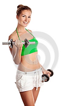 Cute fitness girl working out with dumbbells