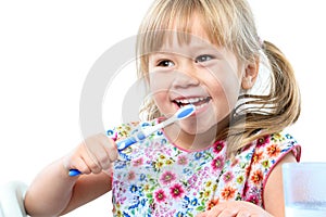 Cute five year old brushing teeth.