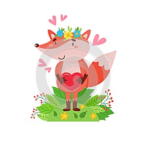 A cute fox stands in a clearing and holds a heart in its paws.