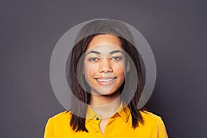 Cute friendly black girl student smiling, close up portrait