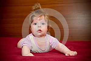 Cute funny baby girl with cheerful coiffure photo