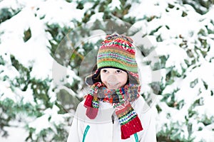 Cute funny child playing in a snowy forest