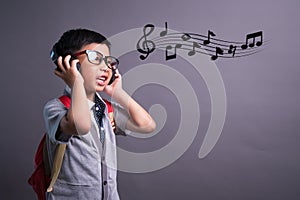 Cute funny children in dance studio, Cute little boy in headphones listening to music on color background