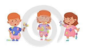 Cute funny creative kids in stained clothes holding paint brushes set cartoon vector illustration