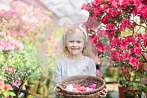 Cute funny girl with Easter bunny ears at garden. easter concept. Laughing child at Easter egg hunt