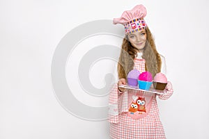 Cute funny girl with slime in the kitchen. The girl cooks and bakes her muffins, makes a cake and slime.