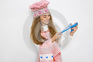 Cute funny girl with slime in the kitchen. The girl cooks and bakes her muffins, makes a cake and slime.