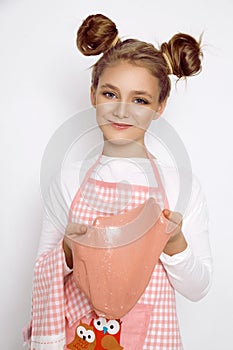 Cute funny girl with slime in the kitchen. The girl cooks and bakes her muffins, makes a cake and slime.