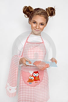 Cute funny girl with slime in the kitchen. The girl cooks and bakes her muffins, makes a cake and slime.