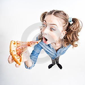 Cute funny girl with two pony tails eating pizza - wide angle shot