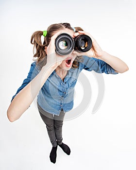 Cute funny girl with two pony tails looking thru photo lenses- wide angle