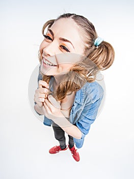 Cute funny girl with two pony tails smiling - wide angle