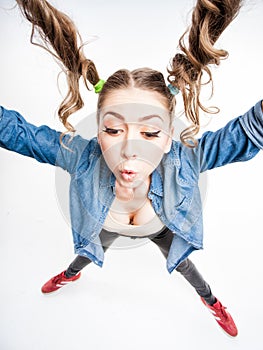 Cute funny girl with two pony tails - wide angle shot