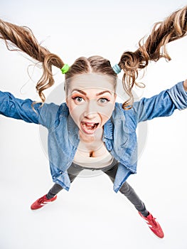 Cute funny girl with two pony tails - wide angle shot