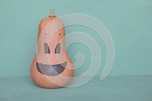 Cute and funny jack o lantern pumpkin smiling face made with butternut squash.