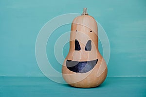 Cute and funny jack o lantern pumpkin smiling face made with butternut squash.