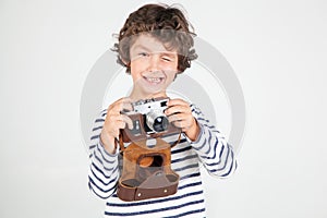 Cute and funny little boy with old film camera over white backgr