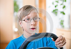 Cute funny little child playing at computer driving