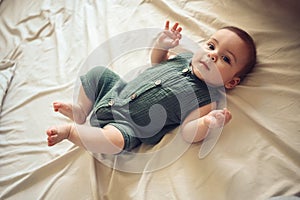 Cute funny newborn little boy peacefully sleeping on white sheets in bed or crib. Baby goods packaging template. Healthy