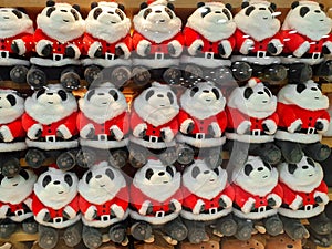 Cute and funny panda in Santa Claus clothes Cute and funny kids toys on shelf in store