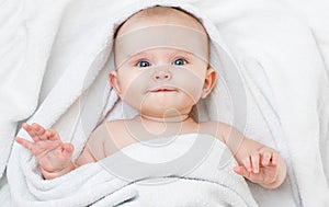 Cute funny smiling baby lying on back in bathing