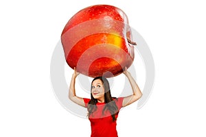 Cute funny young girl holds over herself huge red apple, isolated on a white background