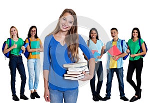 Cute german female student with books and group of students