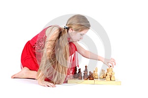 Cute girl 9 years old play in chess