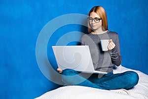 Cute girl against blue wall