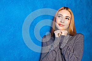 Cute girl against blue wall