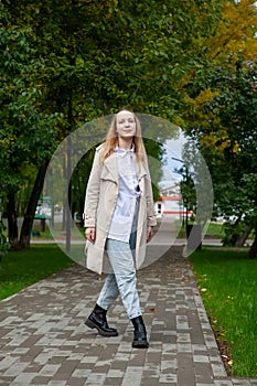 Cute girl on  autumn day against  background of yellow leaves