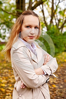 Cute girl on  autumn day against  background of yellow leaves