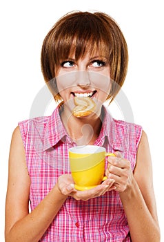 Cute girl with a biscuit and tea cup