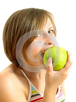 Cute girl biting a green apple