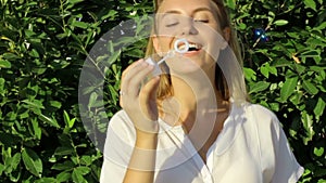 Cute girl blowing soap bubbles