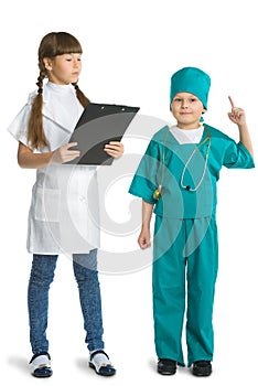 Cute girl and boy doctor in uniform standing