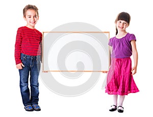 Cute girl and boy holding blank ad