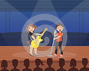 Cute Girl and Boy Playing Guitar and Singing on Stage, Talented Young Musicians Performing at Concert or Music Festival