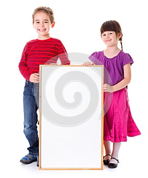 Cute girl and boy showing blank ad