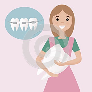 A cute girl with braces on her teeth is happy with a healthy smile.  Banner for advertising children`s dental clinic. Dental care