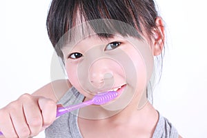 Cute girl brushing her teeth